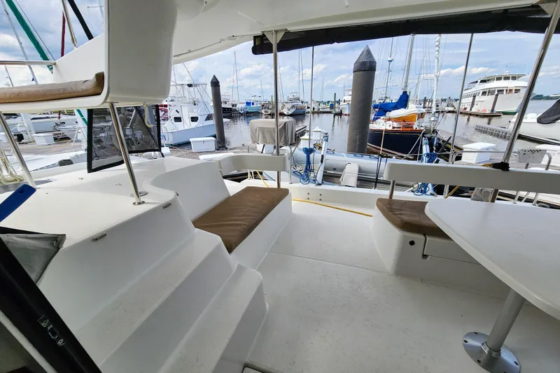 Benevah Yacht Photos Pics 2013 Fountaine Pajot Lipari 41 catamaran interior with marina view, featuring seating and table.