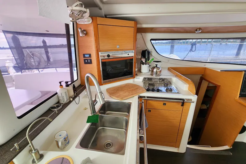 Benevah Yacht Photos Pics Modern kitchen interior of 2013 Fountaine Pajot Lipari 41 catamaran with wood cabinetry.