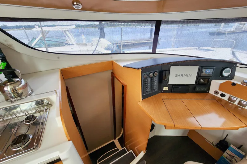 Benevah Yacht Photos Pics Interior of 2013 Fountaine Pajot Lipari 41 catamaran with navigation equipment and kitchenette.