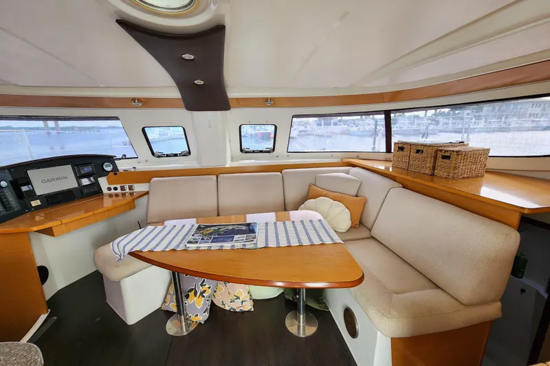 Benevah Yacht Photos Pics Interior of 2013 Fountaine Pajot Lipari 41 catamaran with cozy seating and navigation equipment.