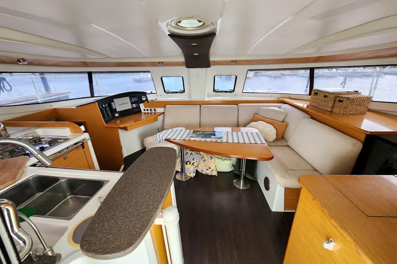 Benevah Yacht Photos Pics Interior of 2013 Fountaine Pajot Lipari 41 catamaran with cozy seating and kitchen area.
