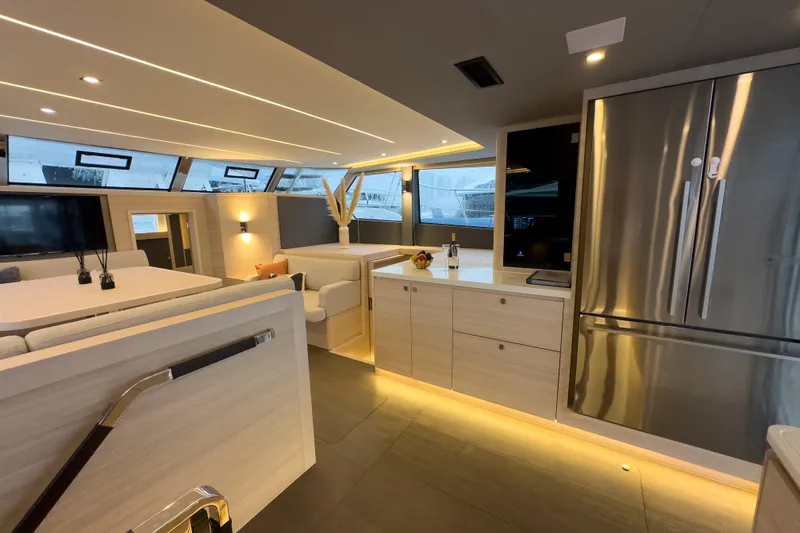  Yacht Photos Pics Luxurious interior of 2025 Aquila 50 Yacht with modern kitchen and seating area.