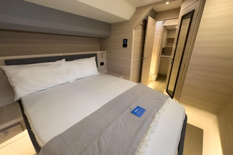  Yacht Photos Pics Luxurious bedroom interior of 2025 Aquila 50 Yacht with modern design and cozy bedding.