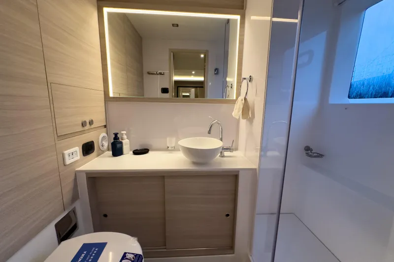  Yacht Photos Pics Modern bathroom interior on 2025 Aquila 50 Yacht, featuring sleek sink and mirror.