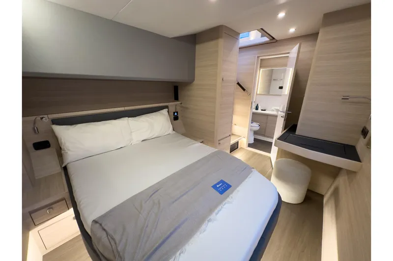  Yacht Photos Pics Luxurious bedroom interior of 2025 Aquila 50 Yacht with modern design and ensuite bathroom.