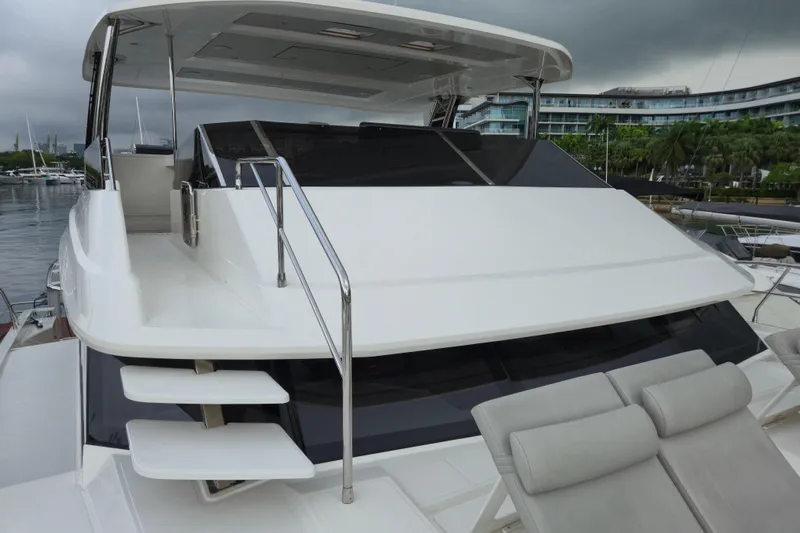  Yacht Photos Pics 2025 Aquila 50 Yacht with sleek design, docked at marina under cloudy sky.
