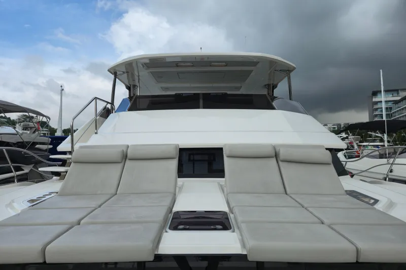  Yacht Photos Pics Aquila 50 Yacht 2025 with luxurious sun loungers on deck, docked at marina.