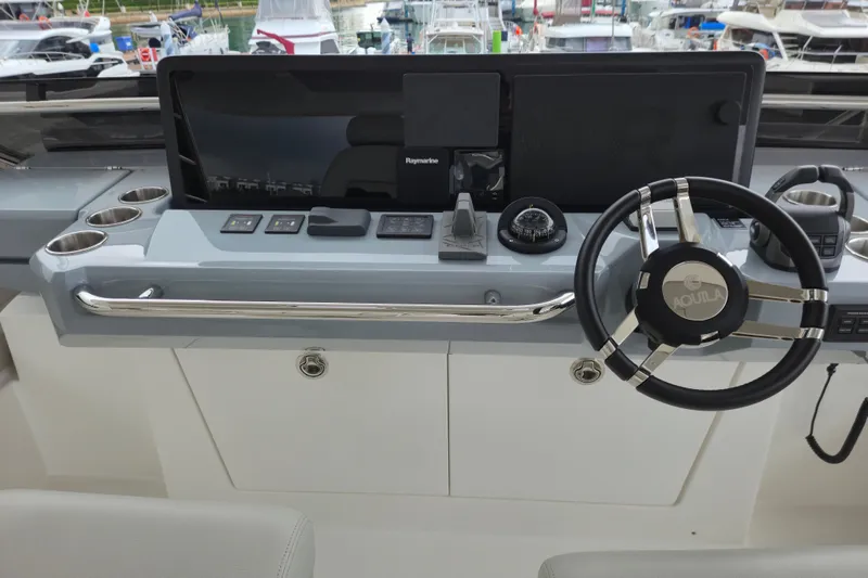  Yacht Photos Pics Helm of 2025 Aquila 50 Yacht with modern controls and steering wheel.