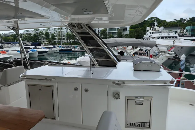  Yacht Photos Pics Aquila 50 Yacht 2025 model docked, featuring sleek outdoor kitchen and marina view.