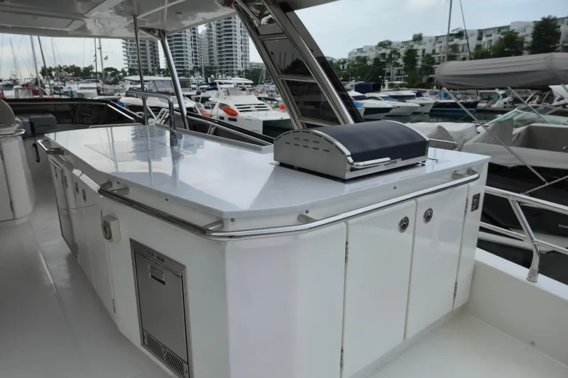  Yacht Photos Pics Outdoor kitchen on 2025 Aquila 50 Yacht with grill and storage, docked at marina.