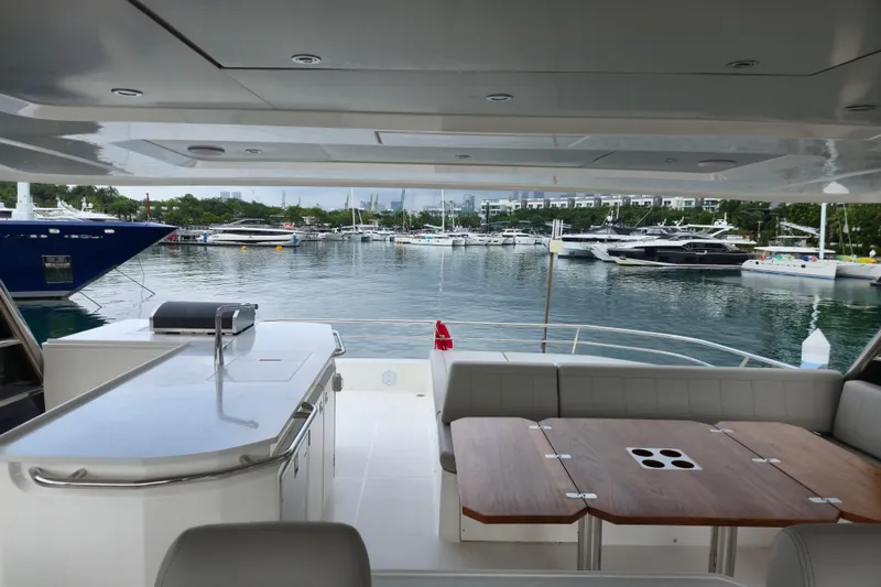  Yacht Photos Pics Aquila 50 Yacht 2025 interior with marina view, featuring a sleek dining area and modern design.