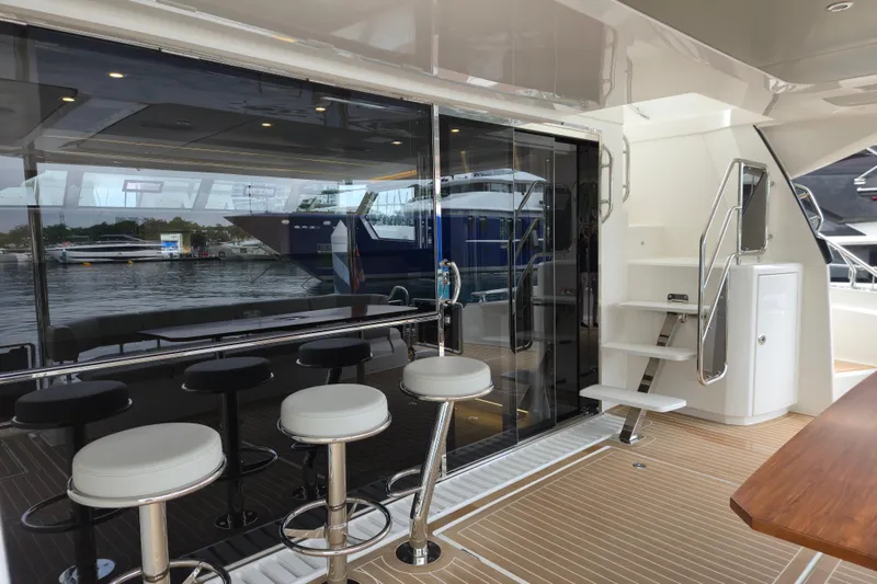  Yacht Photos Pics Luxurious 2025 Aquila 50 Yacht interior with bar stools and sleek design.