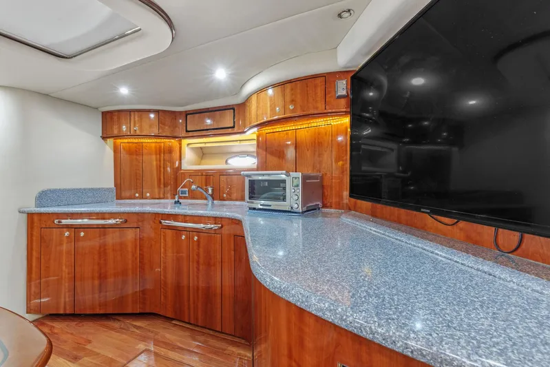  Yacht Photos Pics Luxurious kitchen area in a 2002 Sea Ray 550 Sundancer yacht with modern amenities.