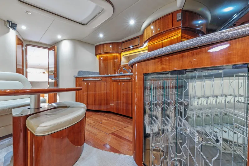  Yacht Photos Pics Luxurious interior of 2002 Sea Ray 550 Sundancer yacht with polished wood finishes and modern amenities.