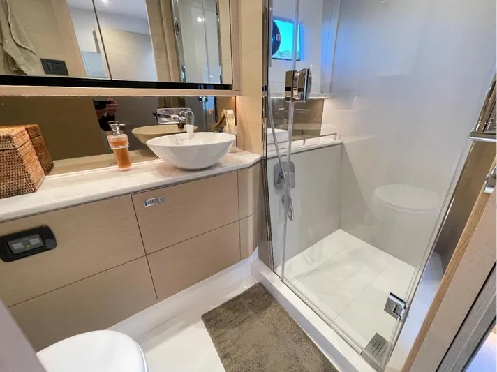 Placid Yacht Photos Pics Luxurious bathroom in 2019 Princess F55 yacht with modern fixtures and glass shower.