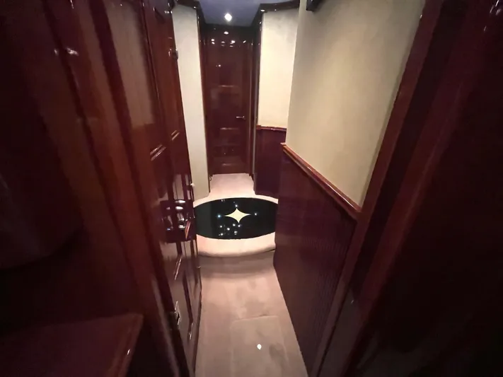 Juli's Priority Yacht Photos Pics Luxurious hallway interior of a 2004 Marquis 59 yacht with polished wood finishes.