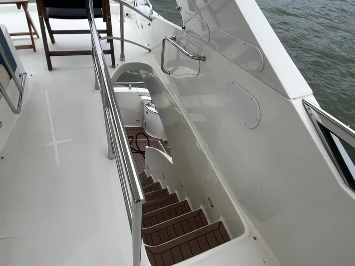 Juli's Priority Yacht Photos Pics Staircase on 2004 Marquis 59 yacht, leading to lower deck with wooden steps.