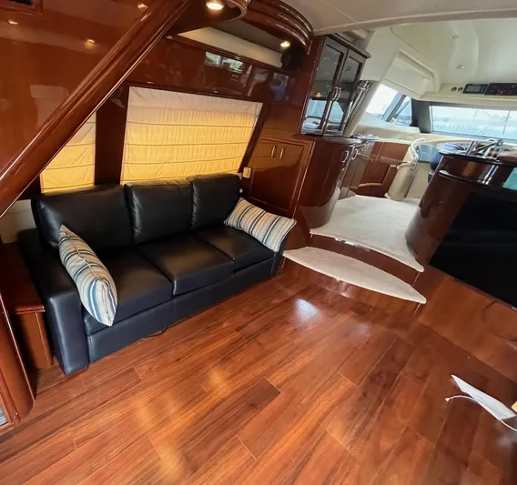 Juli's Priority Yacht Photos Pics Luxurious interior of a 2004 Marquis 59 yacht with wooden flooring and leather seating.