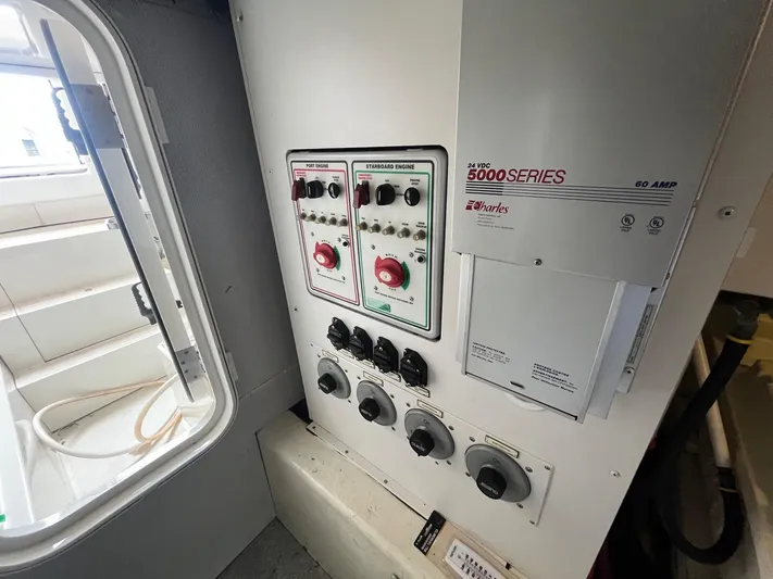 Juli's Priority Yacht Photos Pics Electrical control panel inside a 2004 Marquis 59 yacht, featuring various switches and dials.