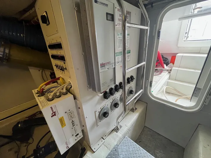 Juli's Priority Yacht Photos Pics Electrical panel inside a 2004 Marquis 59 yacht, featuring control switches and wiring.