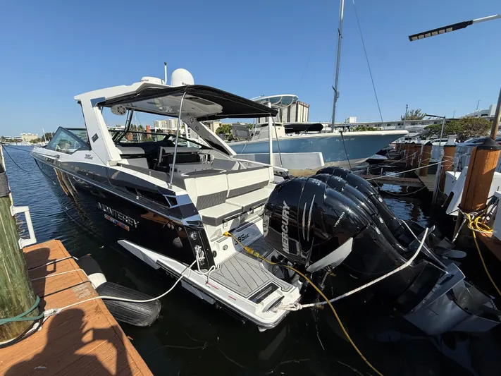  Yacht Photos Pics 2020 Monterey 385 Super Express boat docked with powerful outboard engines, sunny marina setting.