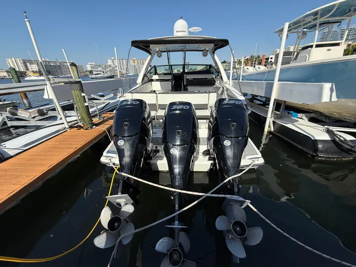  Yacht Photos Pics 2020 Monterey 385 Super Express boat docked with triple outboard engines.