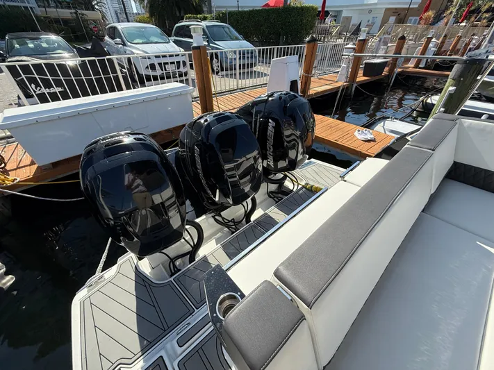  Yacht Photos Pics 2020 Monterey 385 Super Express boat with four powerful outboard engines docked at a marina.