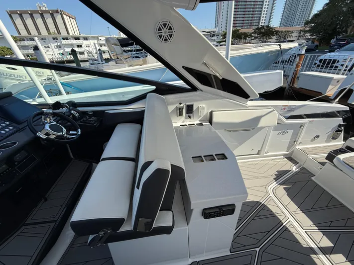  Yacht Photos Pics 2020 Monterey 385 Super Express yacht interior with modern seating and steering area.