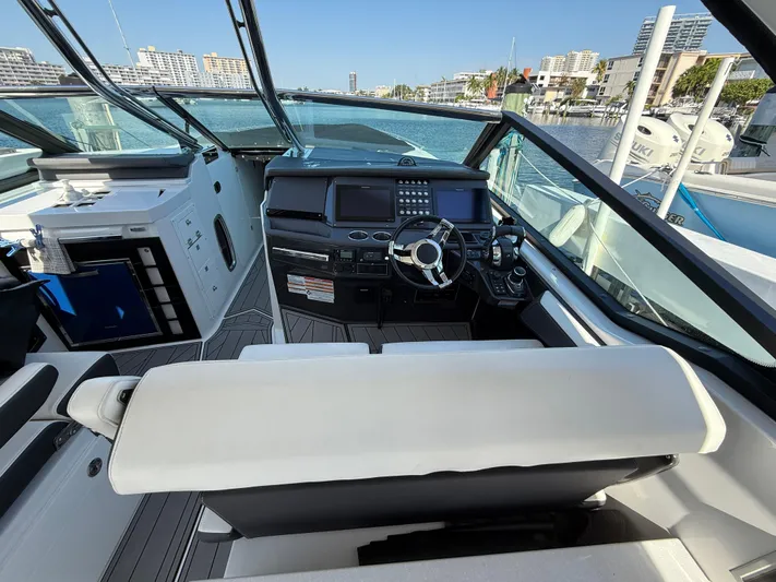  Yacht Photos Pics 2020 Monterey 385 Super Express boat cockpit with modern controls and waterfront view.