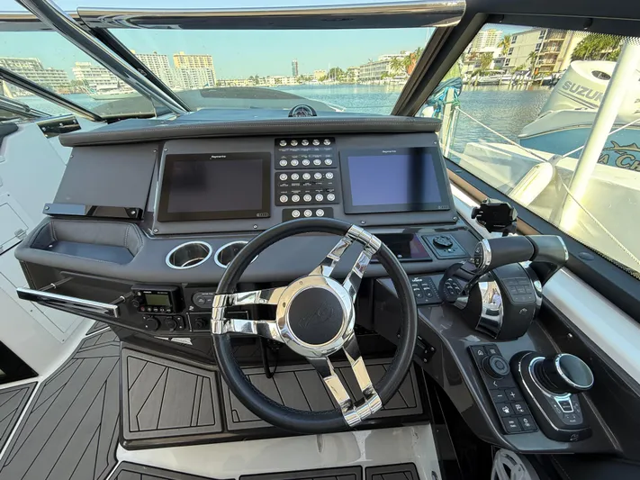  Yacht Photos Pics Cockpit of 2020 Monterey 385 Super Express boat with modern controls and dual screens.
