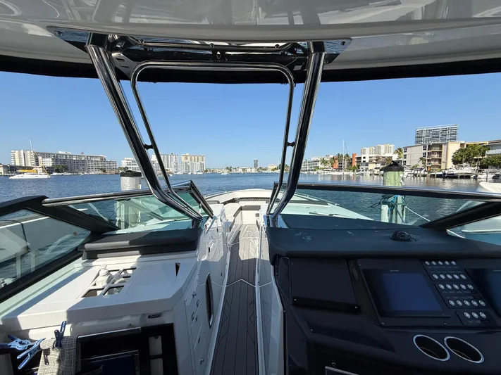  Yacht Photos Pics 2020 Monterey 385 Super Express yacht cockpit with cityscape view in the background.