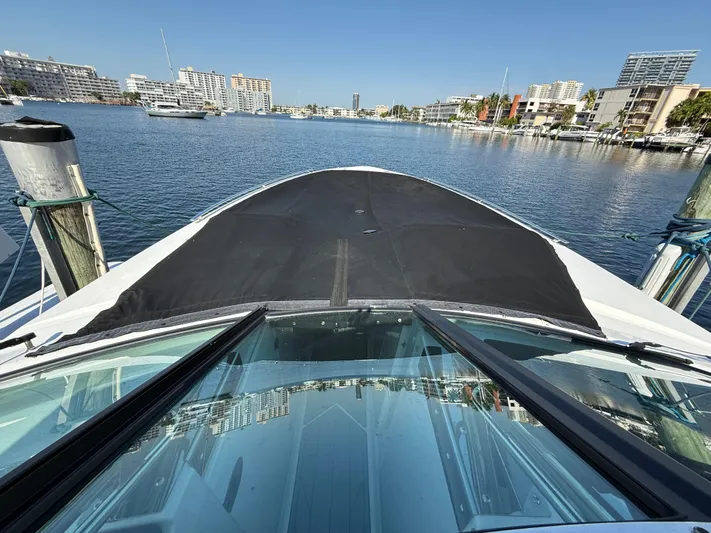  Yacht Photos Pics 2020 Monterey 385 Super Express yacht docked in a marina with cityscape background.