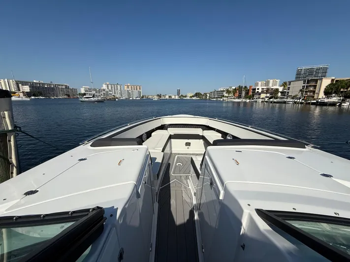  Yacht Photos Pics 2020 Monterey 385 Super Express yacht docked in a marina with cityscape background.