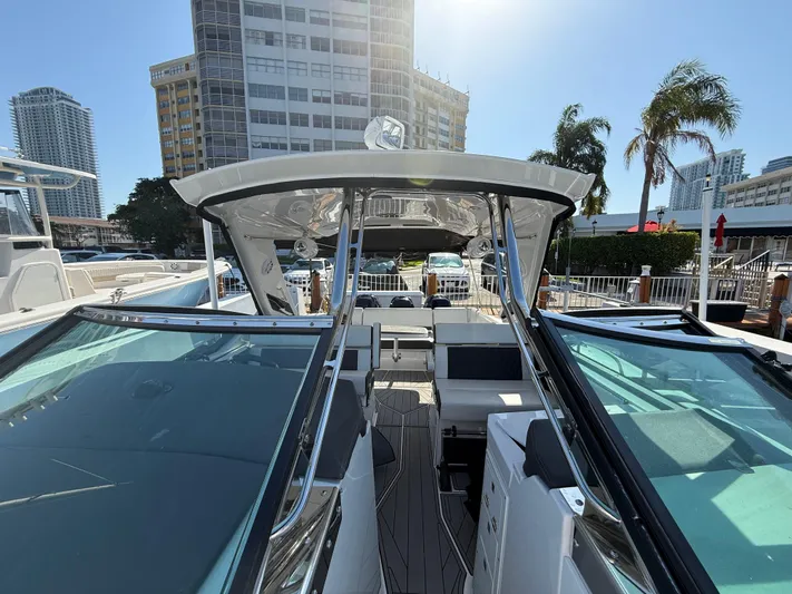  Yacht Photos Pics 2020 Monterey 385 Super Express boat docked in a sunny urban marina.