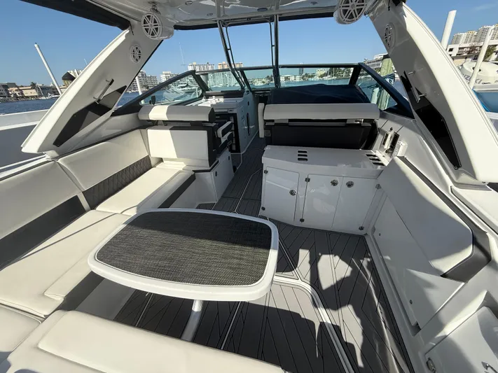  Yacht Photos Pics 2020 Monterey 385 Super Express yacht interior with seating and table, docked in a marina.