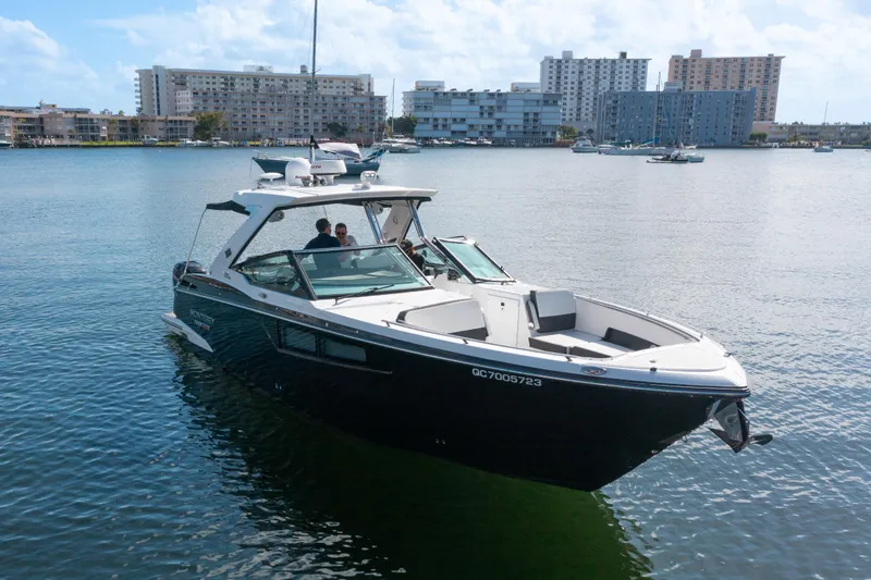  Yacht Photos Pics 2020 Monterey 385 Super Express boat on calm water with cityscape background.