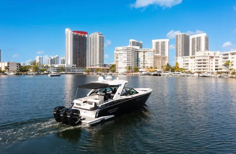  Yacht Photos Pics Monterey 385 Super Express 2020 cruising in urban waterfront with skyscrapers.