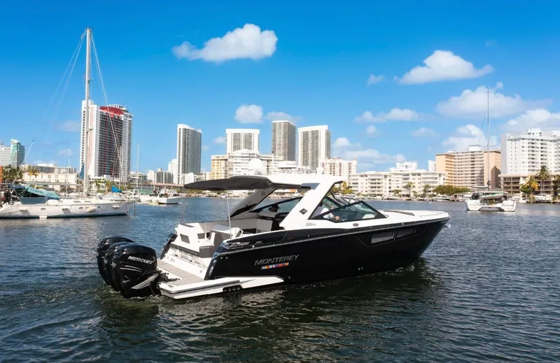  Yacht Photos Pics 2020 Monterey 385 Super Express boat cruising in urban marina with city skyline.