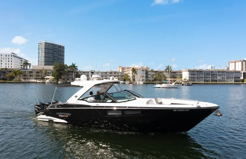  Yacht Photos Pics 2020 Monterey 385 Super Express boat cruising on a sunny day in a city harbor.