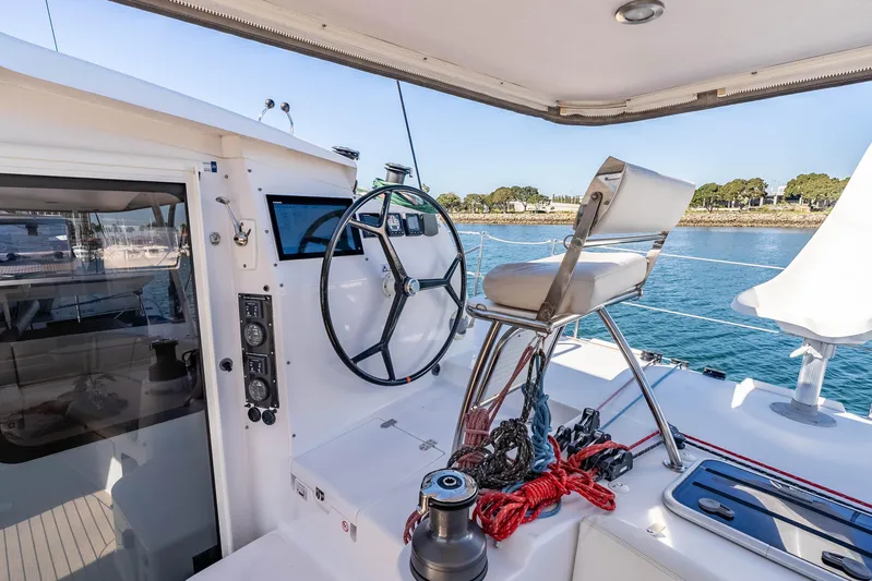  Yacht Photos Pics Helm station of 2014 Outremer 51 catamaran with steering wheel and seating.