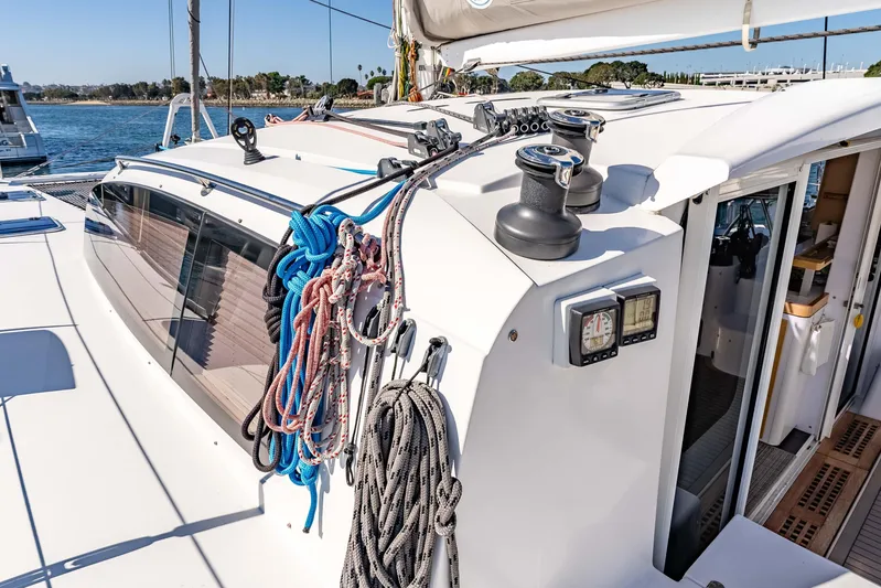  Yacht Photos Pics 2014 Outremer 51 sailboat deck with ropes and winches, docked by the water.