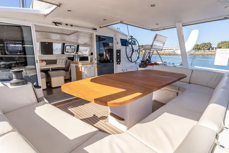  Yacht Photos Pics Luxurious 2014 Outremer 51 catamaran interior with spacious seating and wooden table.