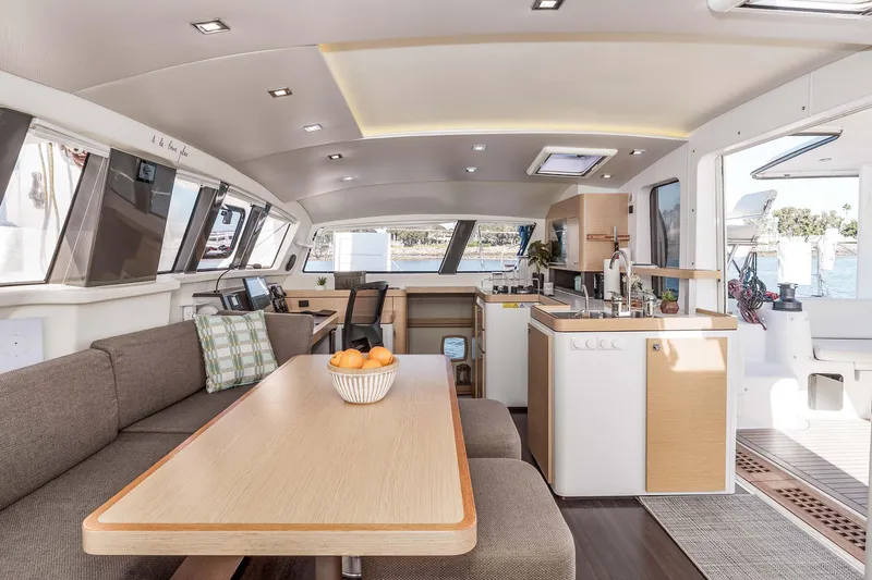  Yacht Photos Pics Luxurious interior of 2014 Outremer 51 catamaran with modern kitchen and dining area.