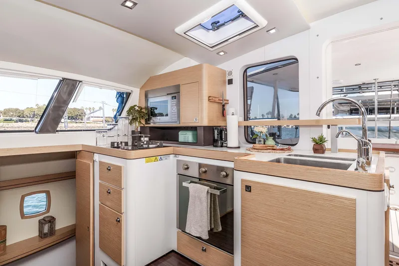  Yacht Photos Pics Modern kitchen interior of 2014 Outremer 51 yacht with sleek design and ample natural light.