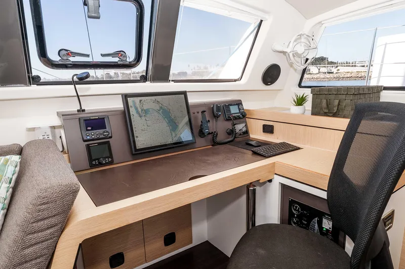  Yacht Photos Pics Navigation station of 2014 Outremer 51 catamaran with modern equipment and comfortable seating.
