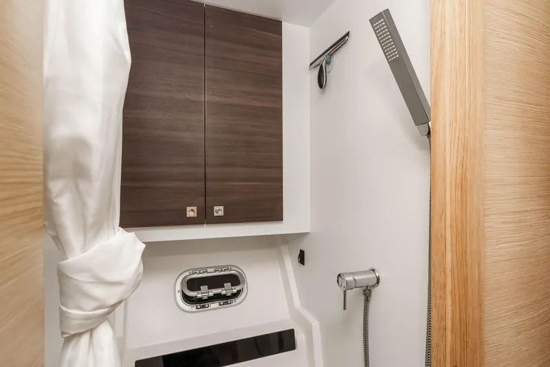  Yacht Photos Pics Bathroom interior of 2014 Outremer 51 yacht with modern shower and wooden cabinets.