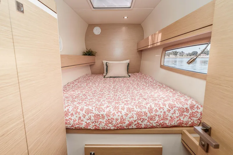  Yacht Photos Pics Cozy cabin interior of 2014 Outremer 51 yacht with floral bedding and window view.