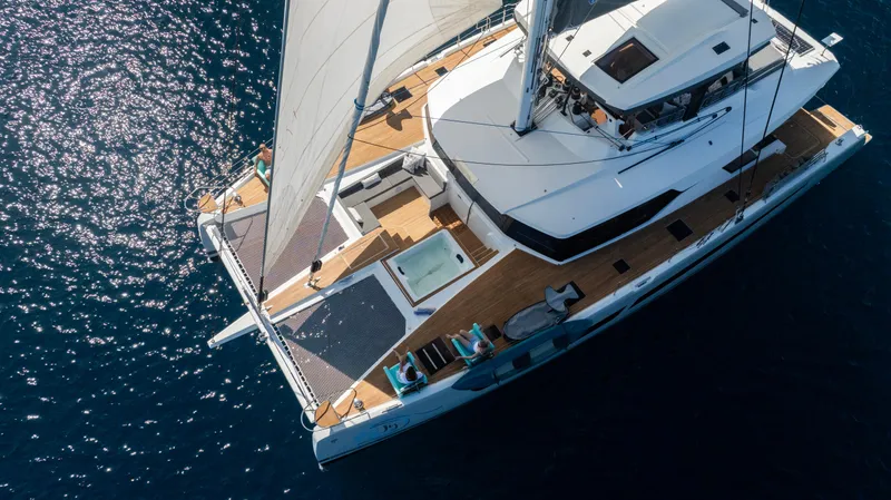 My Ty Yacht Photos Pics Aerial view of 2021 Fountaine Pajot Catamaran Alegria 67 sailing on blue water.