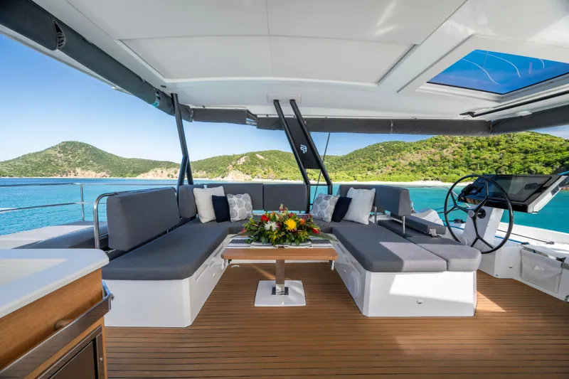 My Ty Yacht Photos Pics Luxurious 2021 Fountaine Pajot Catamaran Alegria 67 with elegant seating and scenic ocean view.