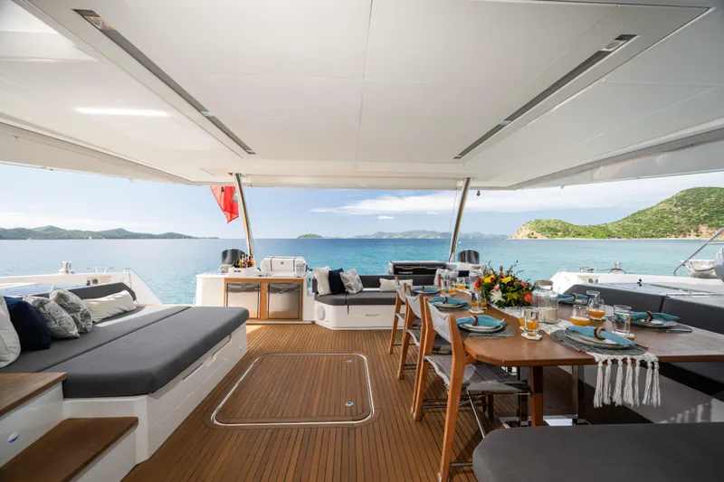 My Ty Yacht Photos Pics Luxurious 2021 Fountaine Pajot Catamaran Alegria 67 with elegant outdoor dining area.